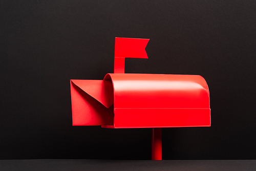 red envelope in metallic post box on black