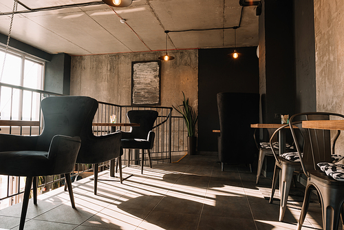 balcony with tables and chairs in modern loft coffee house in sunshine