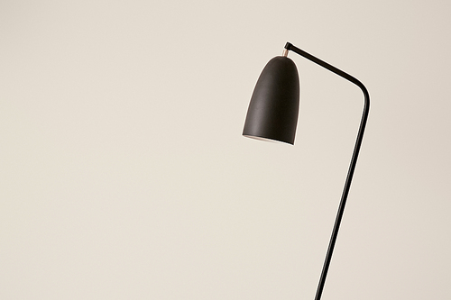 black lamp against white wall in apartment