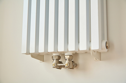 modern heating radiator near white wall in apartment