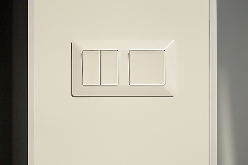 modern switch on white wall in apartment