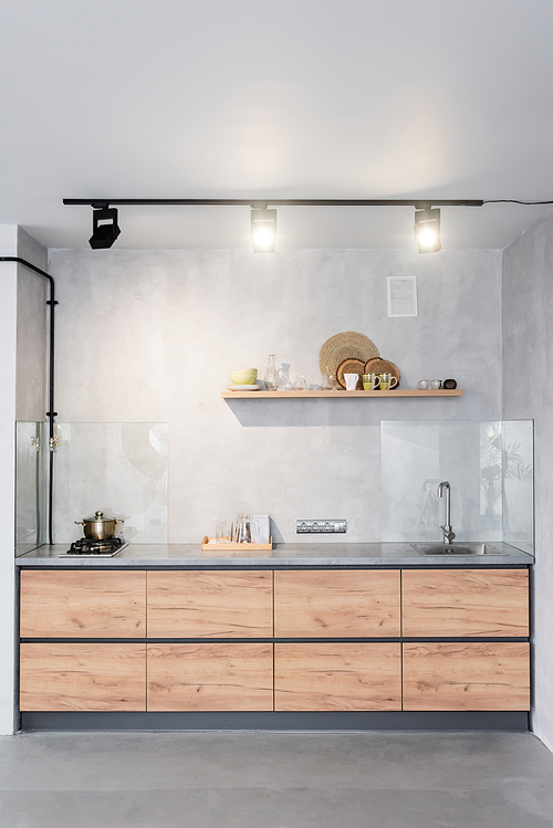 Spacious, minimalistic kitchen with concrete walls