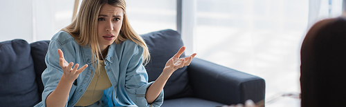 depressed woman talking and gesturing during psychological consultation, banner