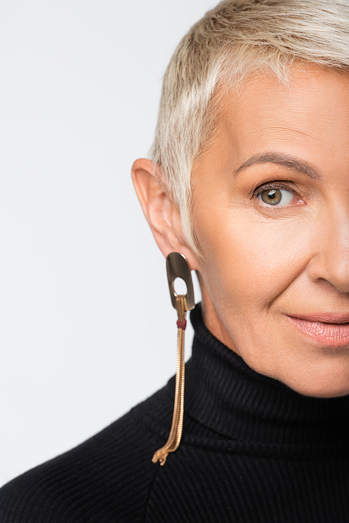 cropped view of cheerful senior woman with long earring and turtleneck  isolated on grey