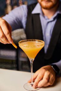 cropped view of barman holding margarita glass with fresh cocktail