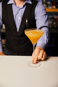 cropped view of barman holding margarita glass with cold and fresh cocktail