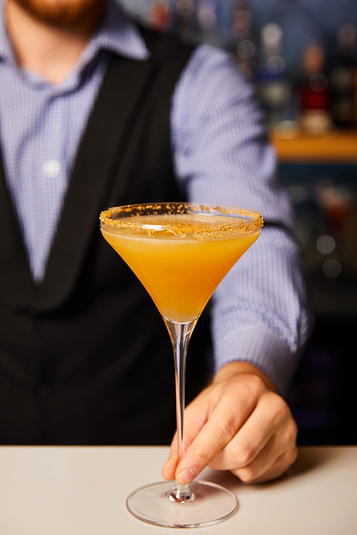 cropped view of barman holding margarita glass with cocktail