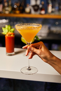 selective focus of woman holding margarita glass with cocktail