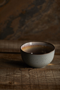 ceramic bowl on rustic wooden table with copy space