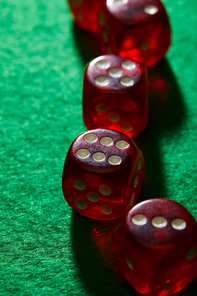 Selective focus of red dice on green background