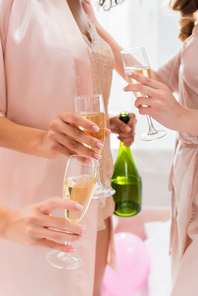 cropped view of girls with glasses and champagne bottle on bachelorette party
