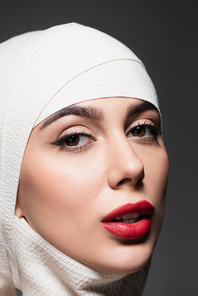 woman with in elastic bandage on head after plastic surgery isolated on grey