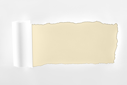 ragged textured white paper with rolled edge on ivory background