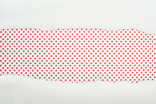 ripped white textured paper with copy space on red dotted background