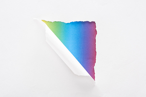 white torn and rolled paper on multicolored background