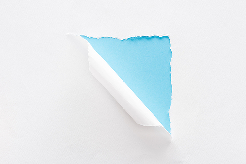 white torn and rolled paper on blue colorful background
