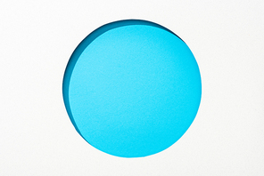cut out round hole in white paper on blue bright colorful background