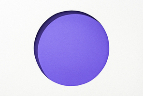 cut out round hole in white paper on violet colorful background