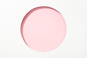 cut out round hole in white paper on pink and white striped colorful background