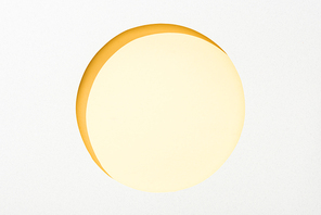 cut out round hole in white paper on yellow background