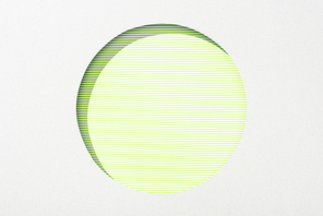 cut out round hole in white paper on lime green striped background