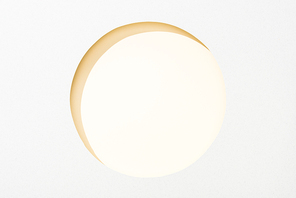 cut out round hole in white paper on light yellow background