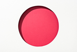 cut out round hole in white paper on red background