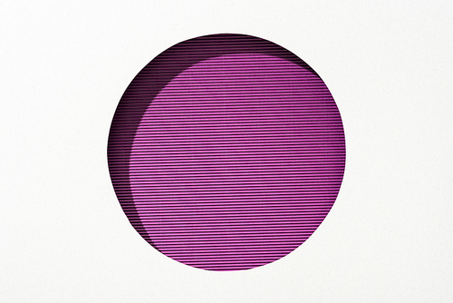 cut out round hole in white paper on striped purple background