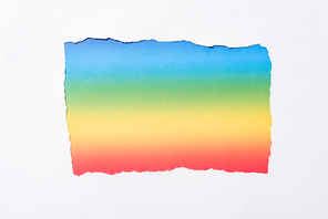 rainbow colorful background in white torn paper hole