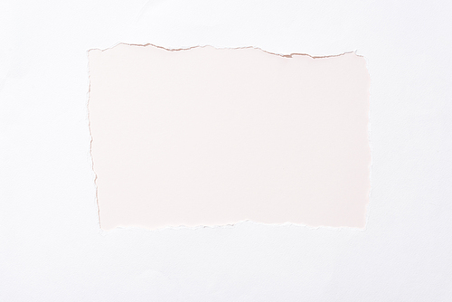 beige colorful background in white torn paper hole