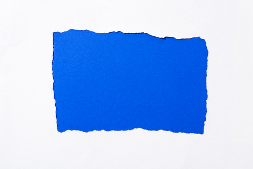 Electric blue colorful background in white torn paper hole
