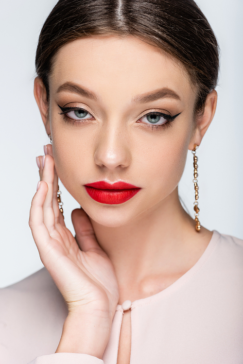 pretty woman in earrings with red lips  isolated on grey