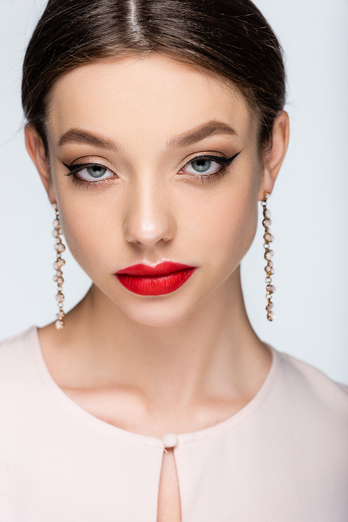 brunette woman in earrings with red lips  isolated on grey