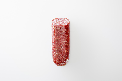 top view of delicious whole salami isolated on white