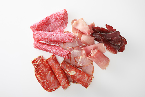 top view of fresh delicious assorted sliced meat isolated on white