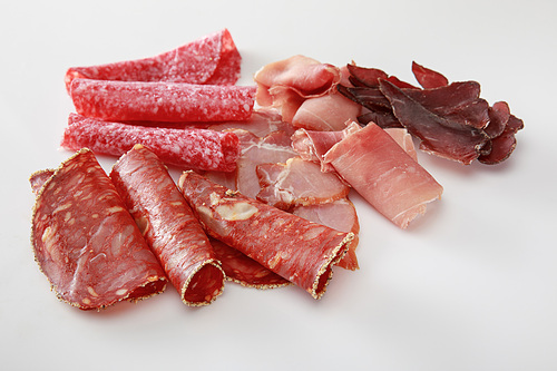 fresh delicious assorted sliced meat isolated on white