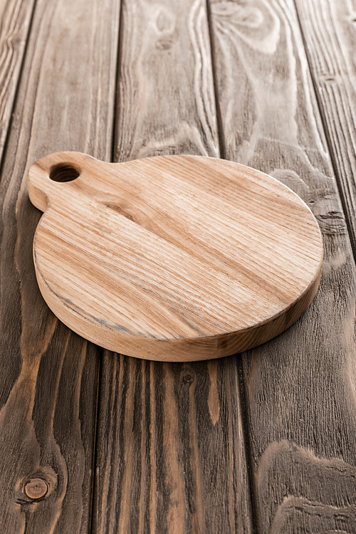 brown empty cutting board on wooden table