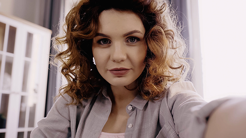 Young curly woman  at home