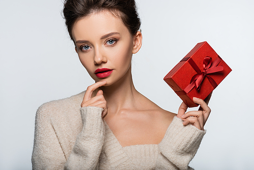 Pretty brunette model  and holding gift isolated on white