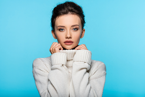 Young woman in sweater  isolated on blue
