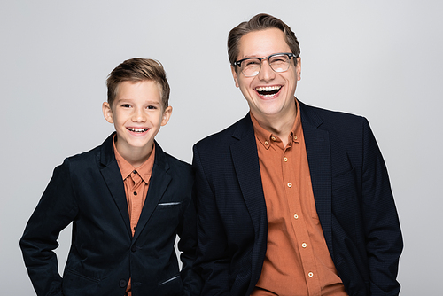 Happy stylish father and son  isolated on grey