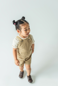 high angle view of asian toddler girl posing on grey
