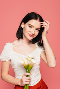 Stylish body positive women holding calla lilies on pink background