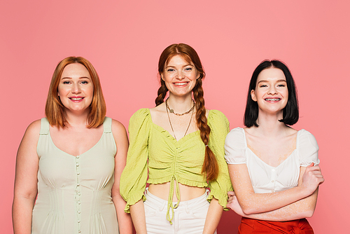 Cheerful body positive women  on pink background