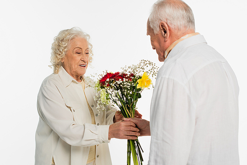 elderly man presenting bouquet of flowers to wife isolated on white