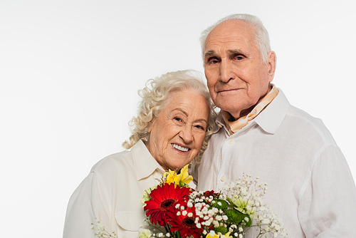 happy elderly couple holding bouquet of flowers and  isolated on white