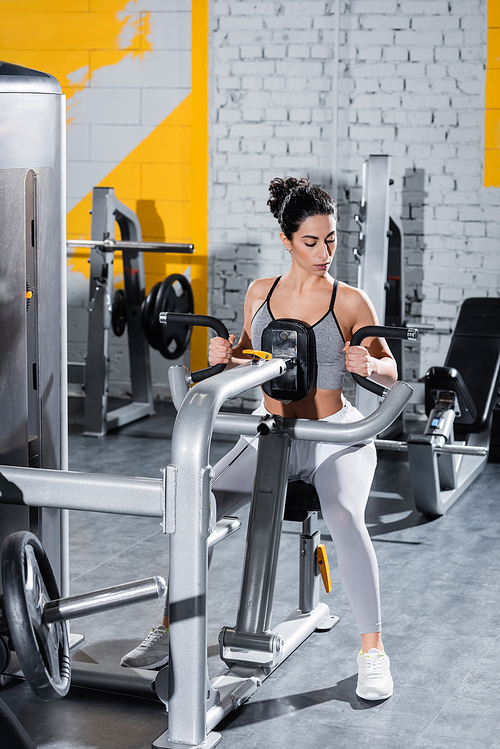 Middle east sportswoman training on ab crunch machine in sports center