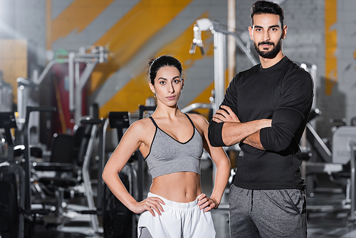 Young middle east sportswoman  near arabian friend in gym