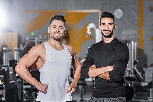 Smiling interracial sportsmen  in blurred gym