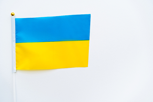 Top view of ukrainian flag on white background with copy space